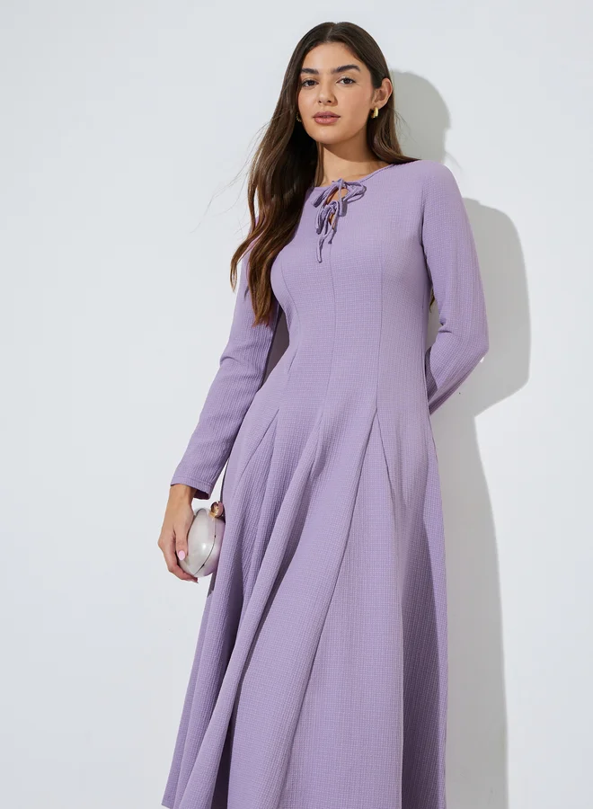 Styli Lilac Textured Pleated Details Tie-Up Neck A-Line Maxi Dress
