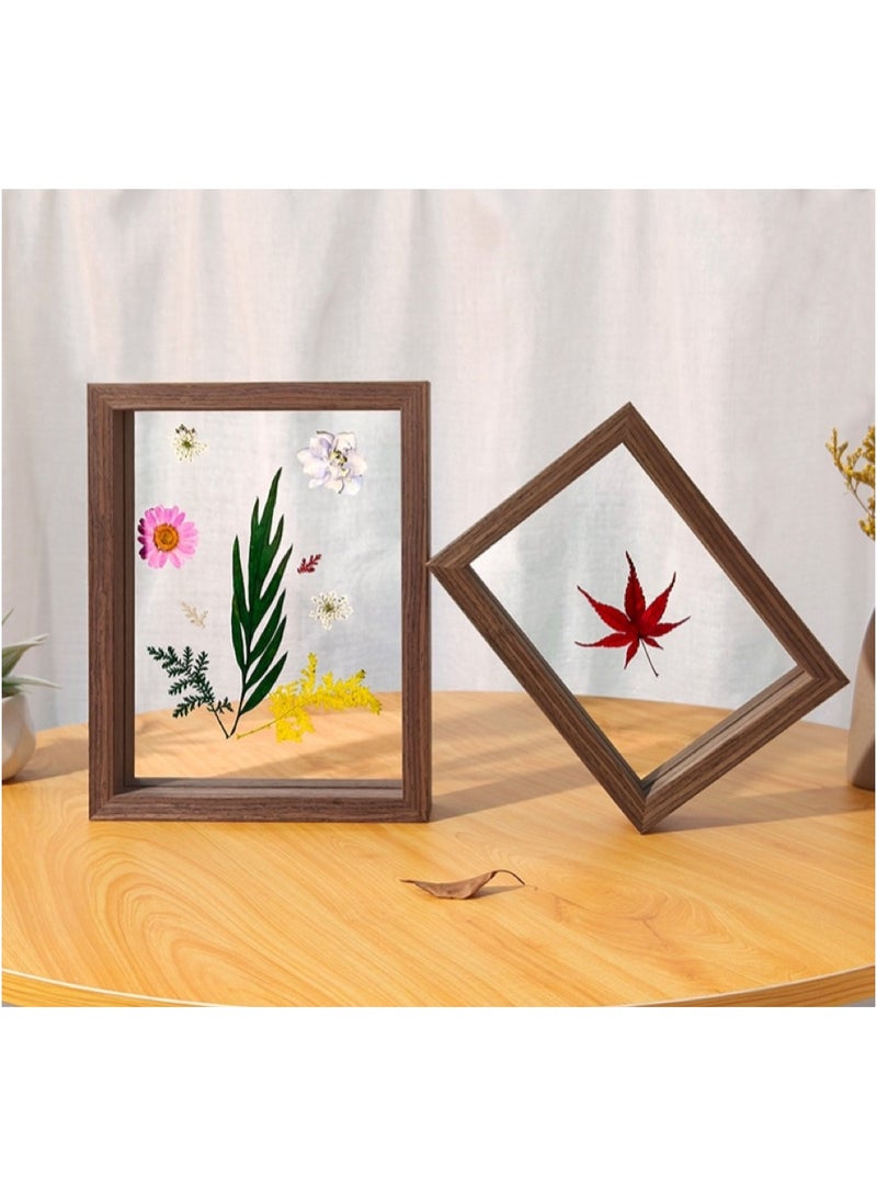 A picture frame with leaves visible from both sides in dark brown in different sizes