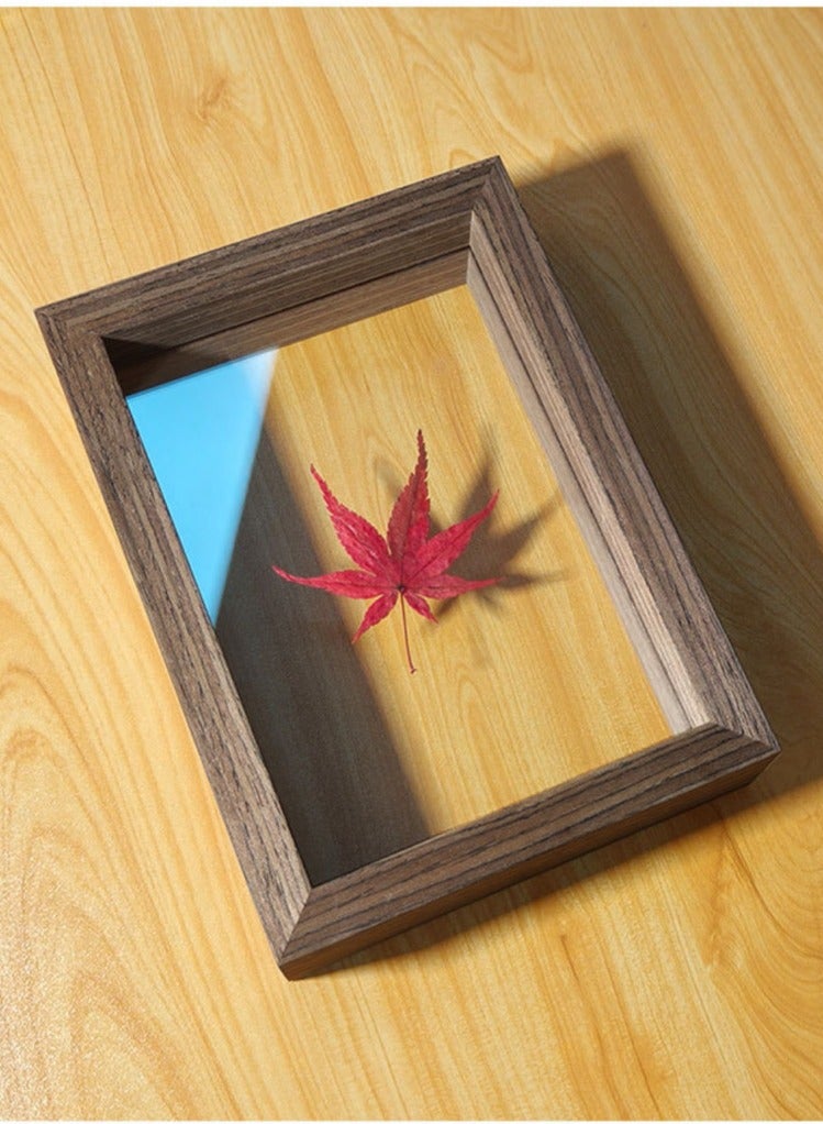 A picture frame with leaves visible from both sides in dark brown in different sizes