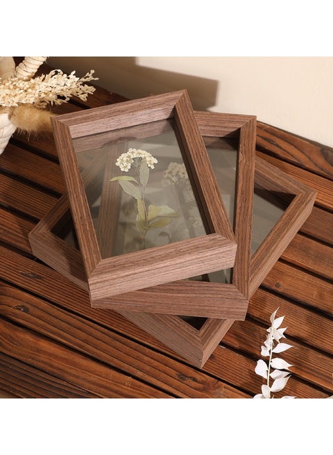 A picture frame with leaves visible from both sides in dark brown in different sizes