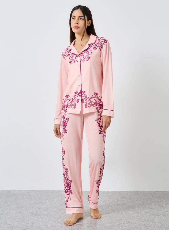 A set of pajama pants and a blouse with a floral p...