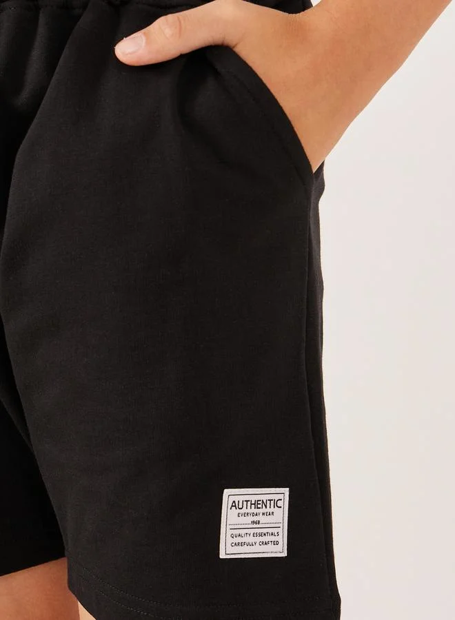 Styli Solid Drawstring Waist Shorts with Badge Detail