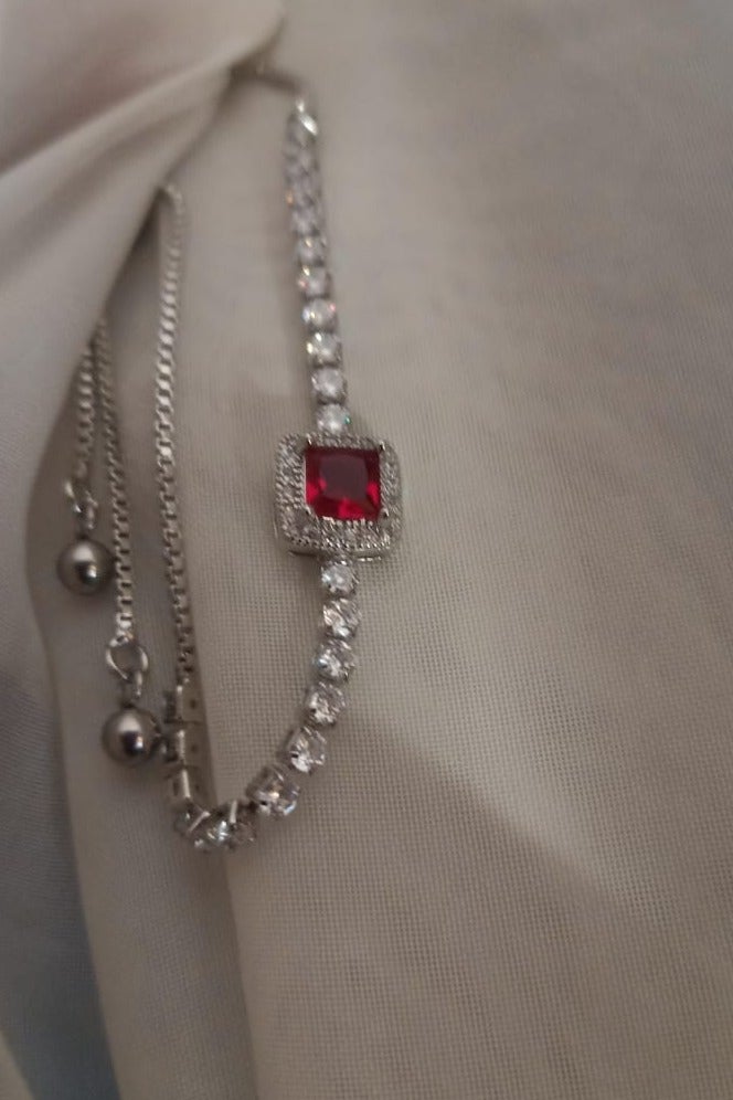Luxuria Tennis bracelet with a red stone in the middle - Image 2