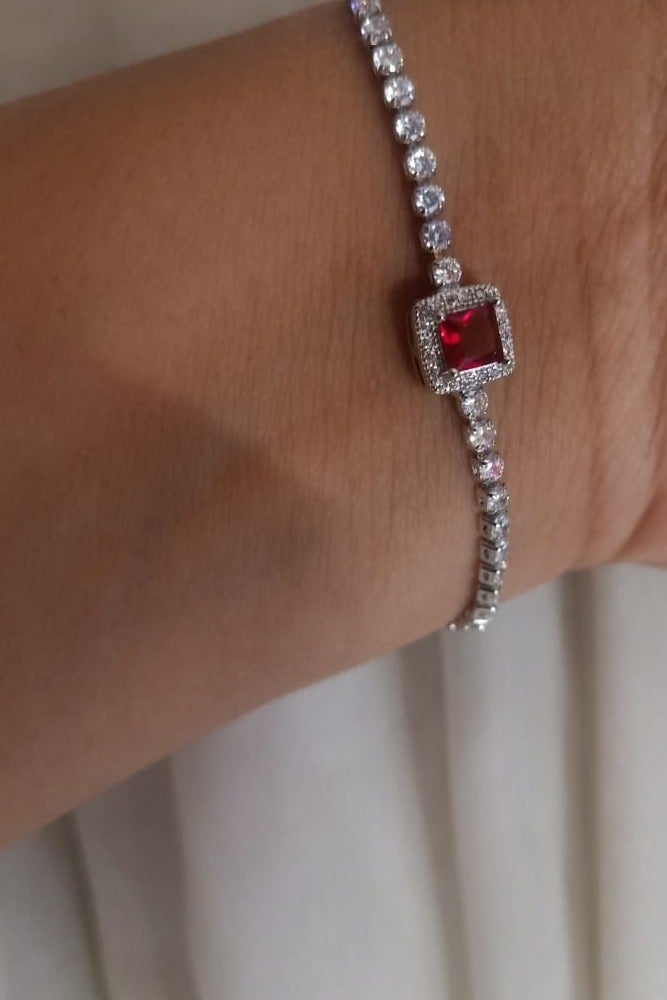 Luxuria Tennis bracelet with a red stone in the middle - Image 3