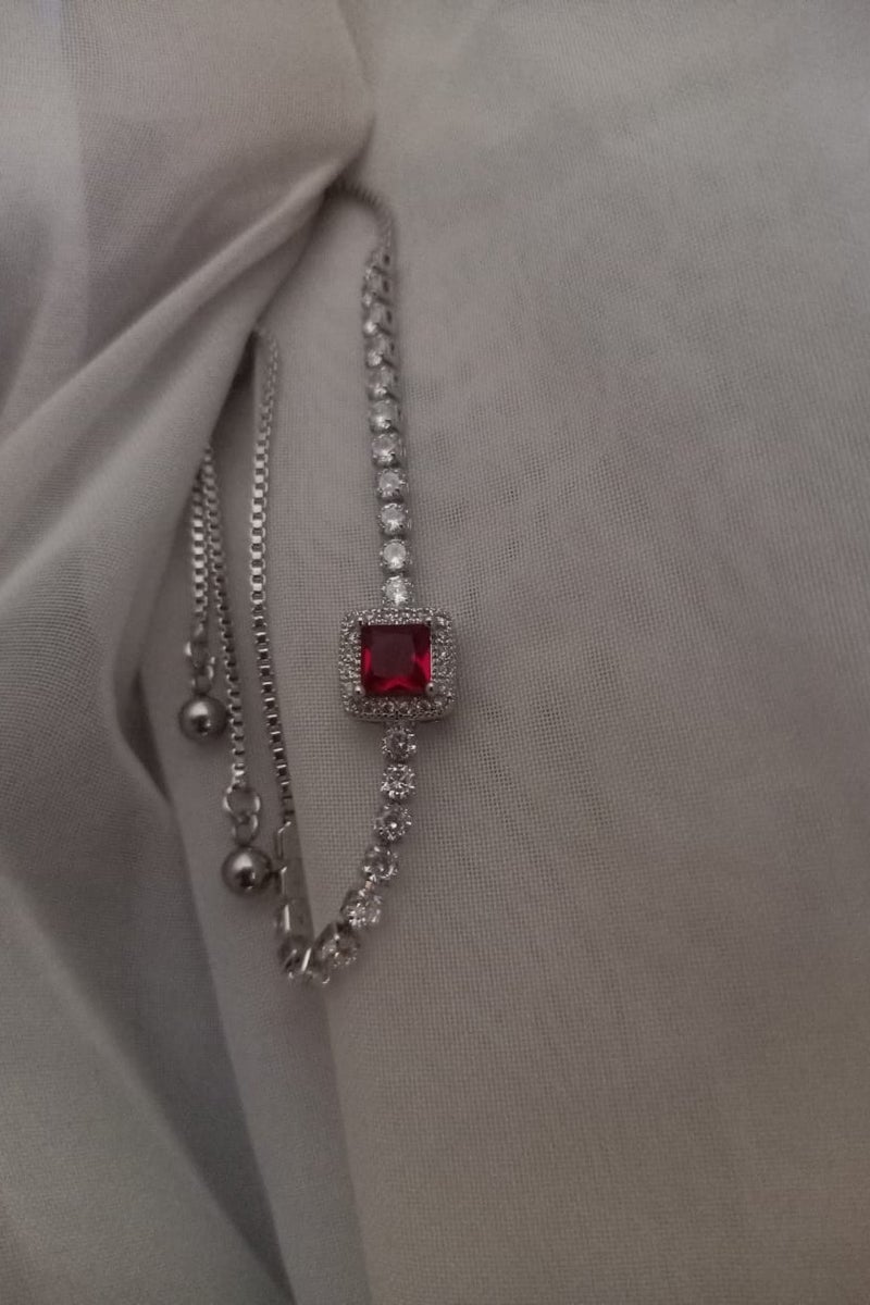 Luxuria Tennis bracelet with a red stone in the middle - Image 4