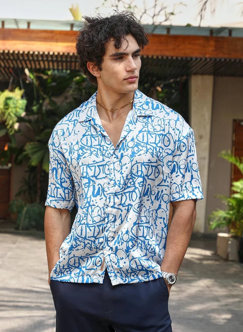 Campus Sutra Campus Sutra Men's Blue & White Graffiti Satin Oversized Shirt For Casual Wear | Cuban Collar | Short Regular Sleeves | Button Closure | Oversized Shirt Crafted With Comfort Fit For Everyday Wear