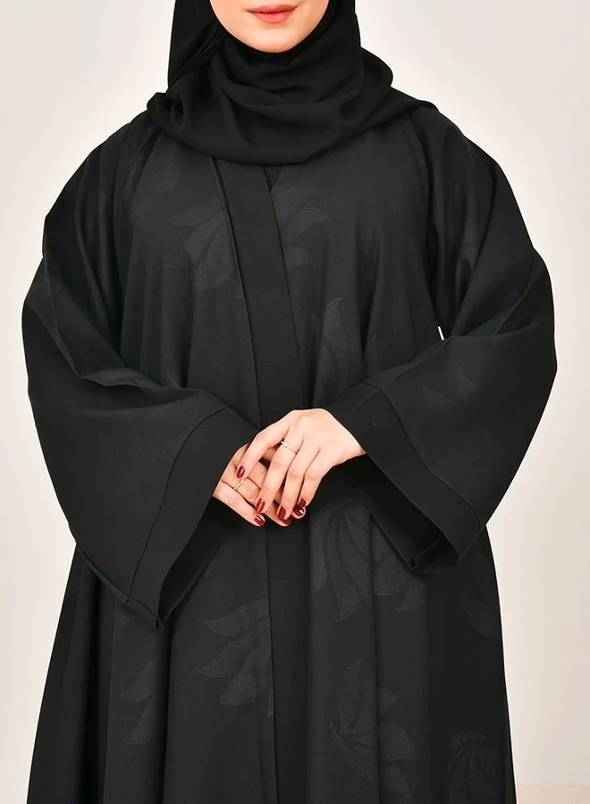 HAWRAA ABAYA Black flared abaya featuring prints across the entire design