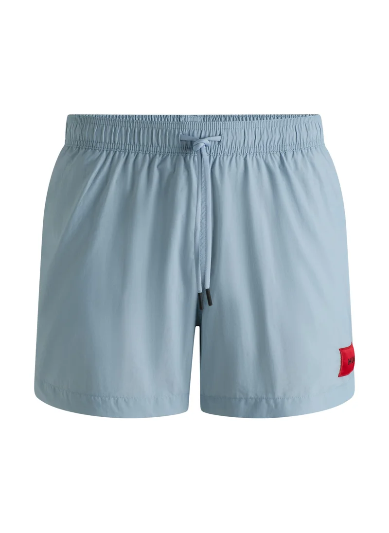 هوجو Fully lined swim shorts with red logo label