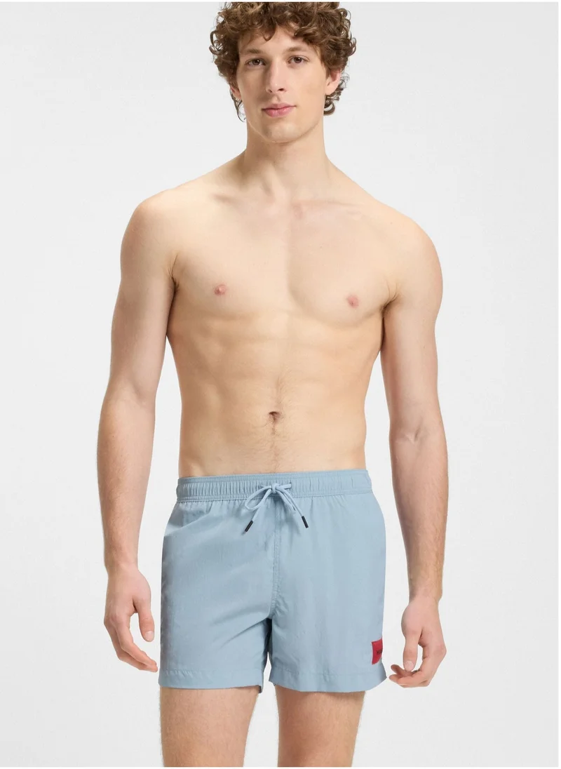 هوجو Fully lined swim shorts with red logo label