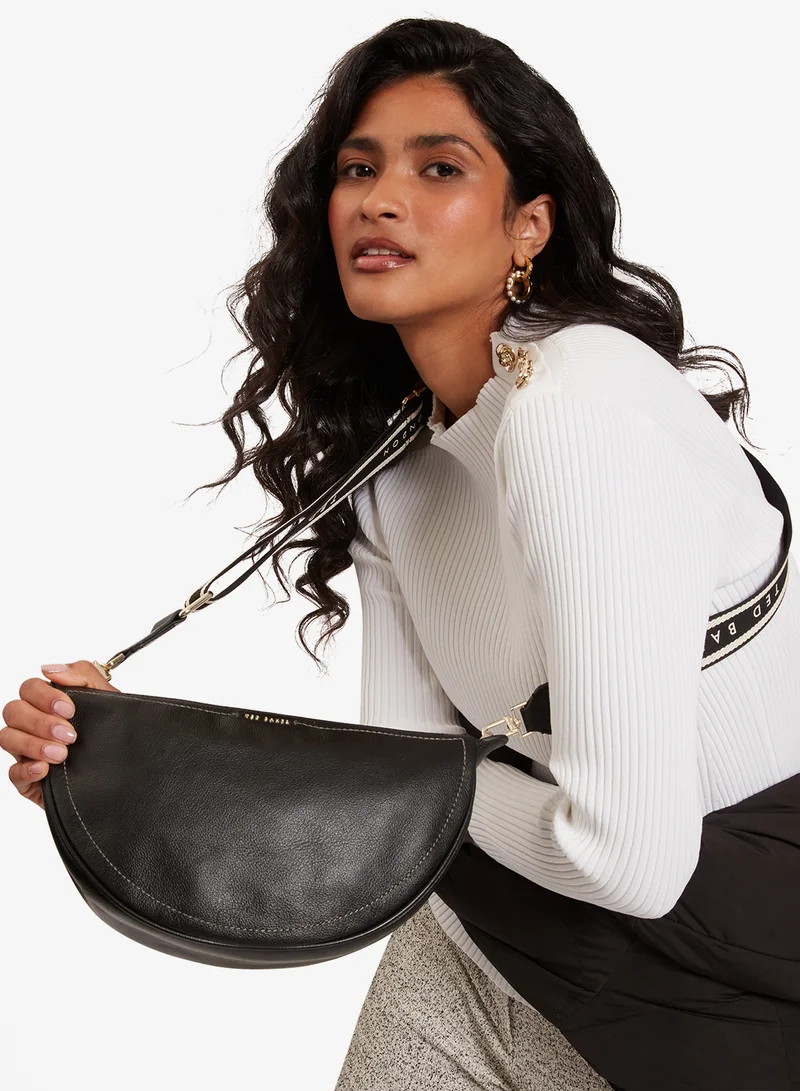 تيد بيكر حقيبة كروس جلدية بشكل نصف قمر بحزام منسوج