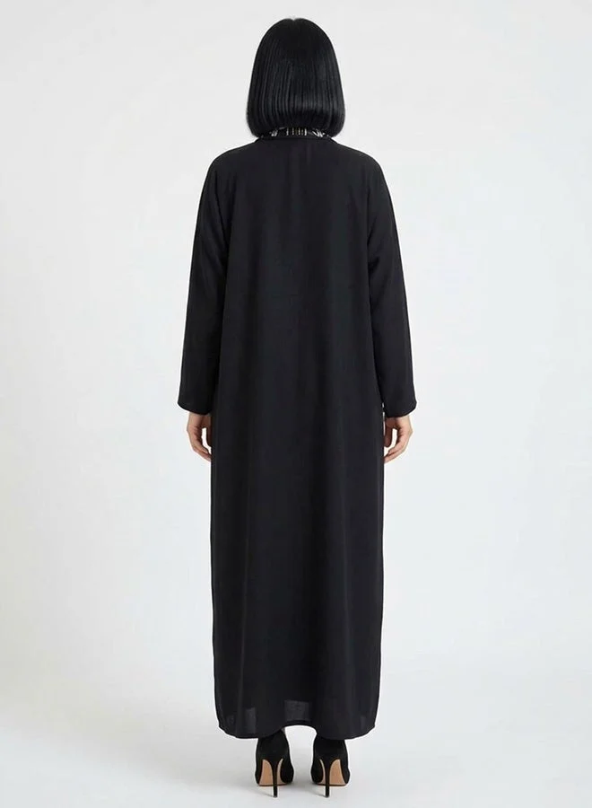 HAWRAA ABAYA Black wrap abaya featuring embroidery and embellishments on the collar
