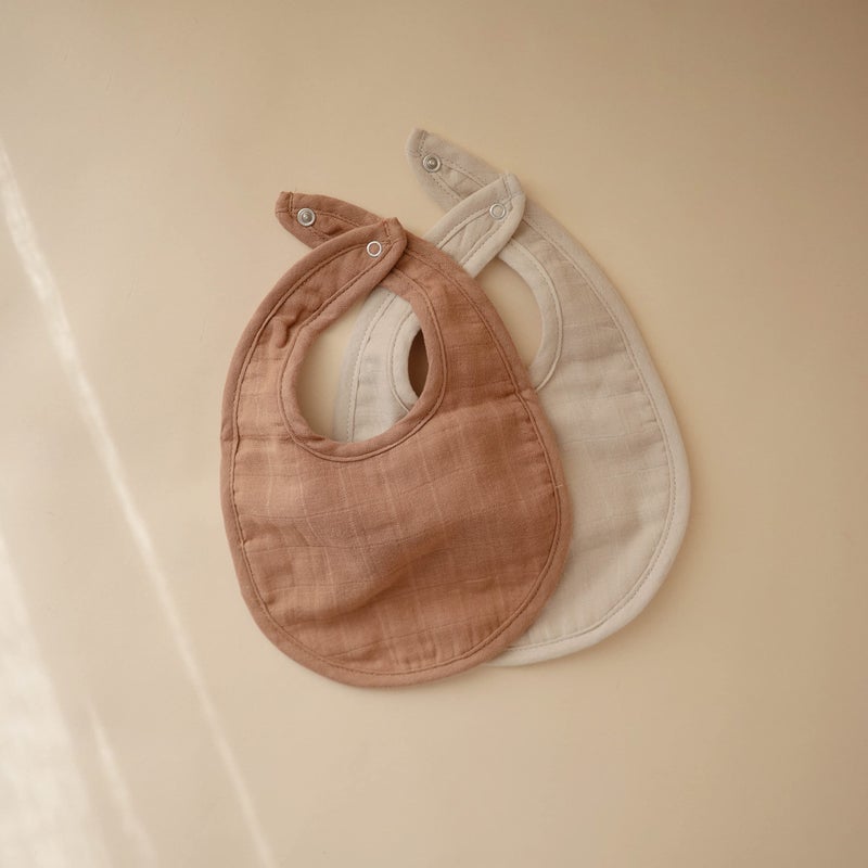 mushie Muslin Baby Bib | Soft Cotton for Infant Drips, Drools & Feedings | Adjustable Fit | 2 Pack (Tan/Fog) - Image 2