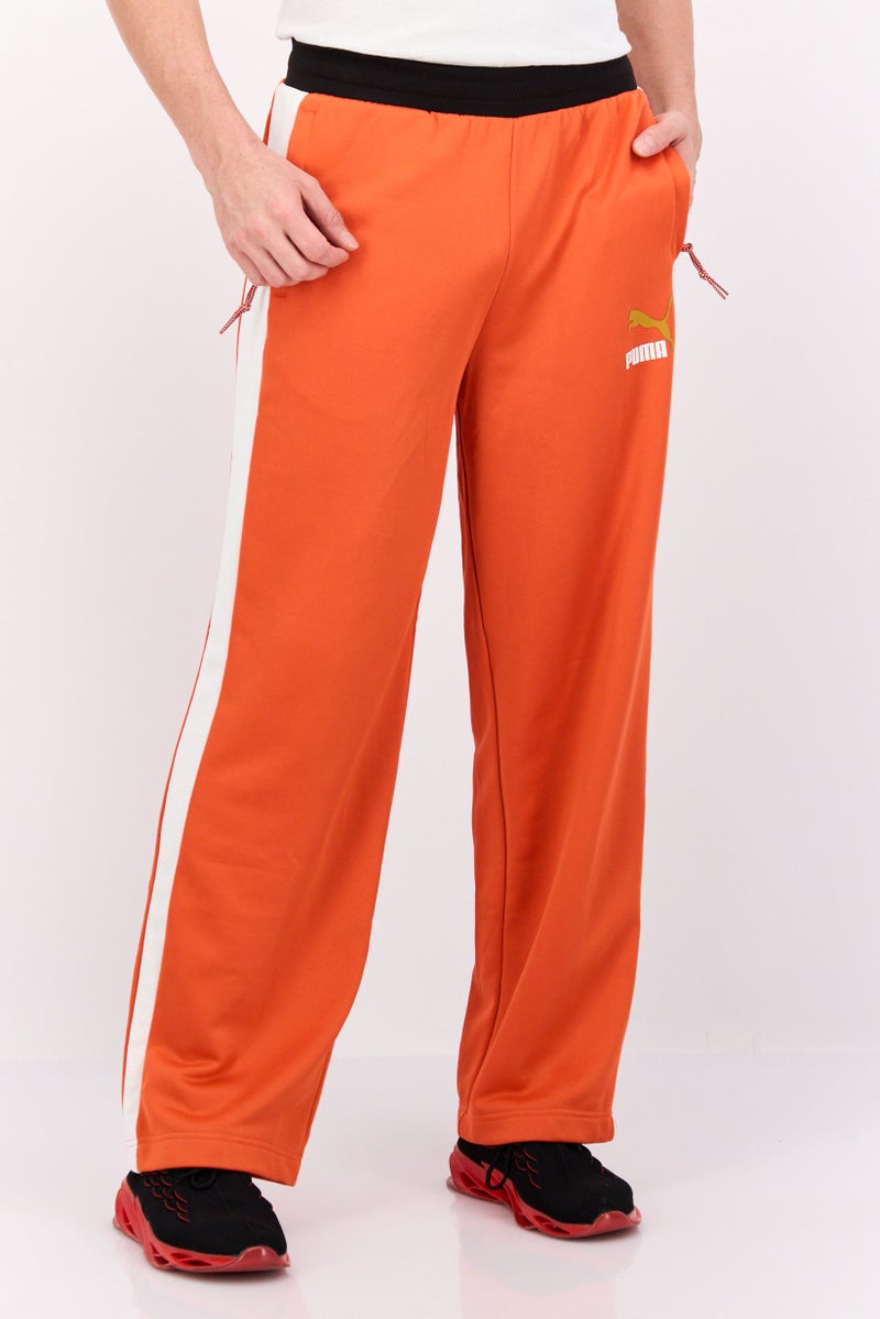 PUMA Men Relaxed Fit Brand Logo Training Track Pants, Orange/White - Image 1