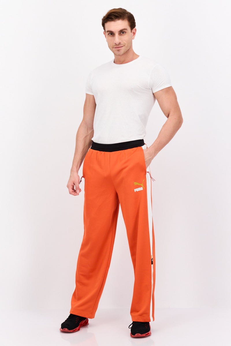 PUMA Men Relaxed Fit Brand Logo Training Track Pants, Orange/White - Image 4