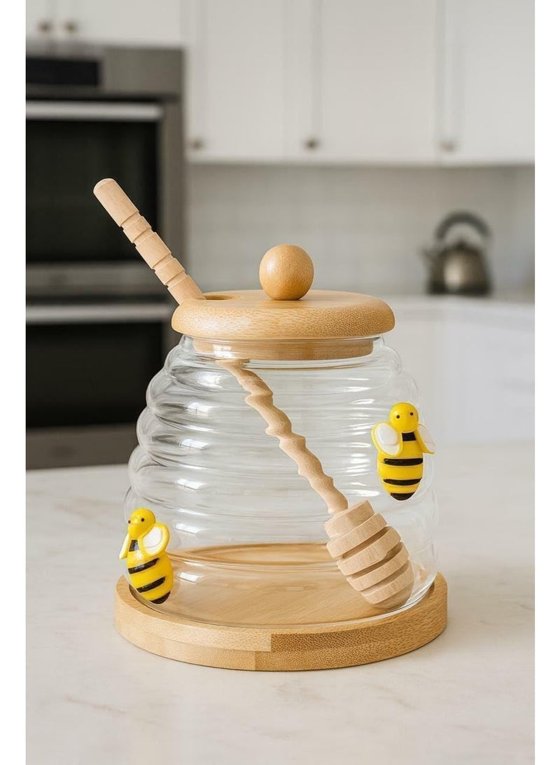 A practical honey jar with an elegant design, it comes with a wooden spoon designed for easy, mess-free honey removal, and a tight-fitting lid. - Image 1