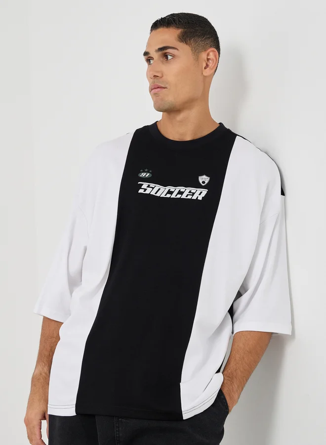 Styli Styli Men Boxy Fit Cut and Sew Panel Printed T-Shirt