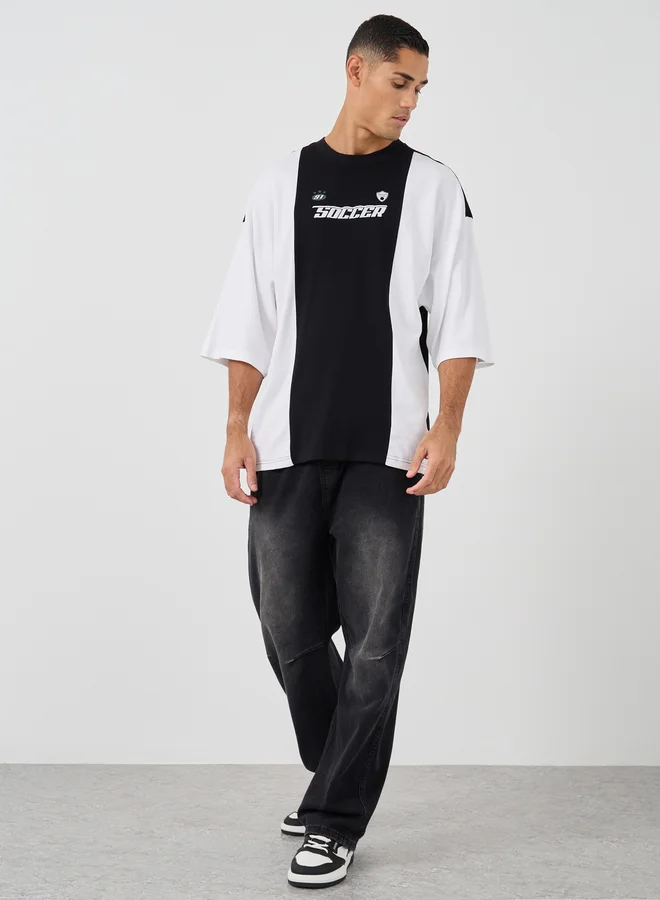 Styli Styli Men Boxy Fit Cut and Sew Panel Printed T-Shirt