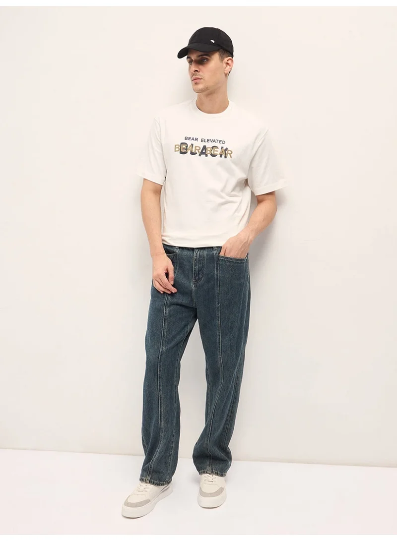 THE BEAR HOUSE  Men's White Graphic Overlapping Text Oversize Crew Neck T-shirt Perfect For Casual Wear, Gym, Travel, Or Layering Stylish And Versatile Essential For Every Wardrobe for Men | Best Price UAE