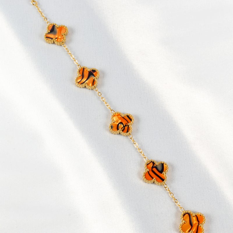 ذا بلاك بيرل اكسسوريز أنسيال أستانليس ستيل ذهبي مع شكل زهرة البرسيم بألوان خلابة - Image 2