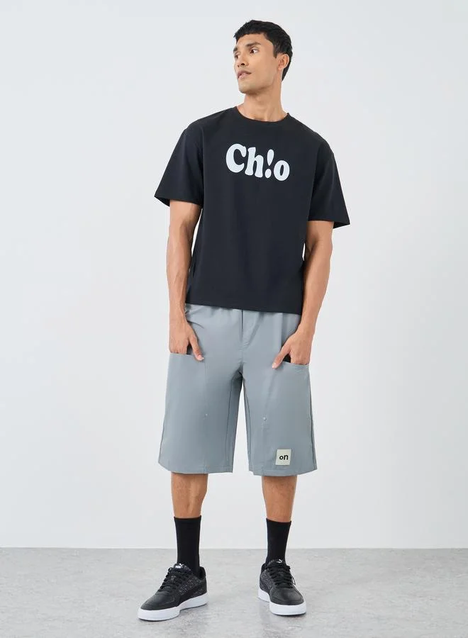 ستايلي Styli Men Grey Oversized Shorts with Badge Detail