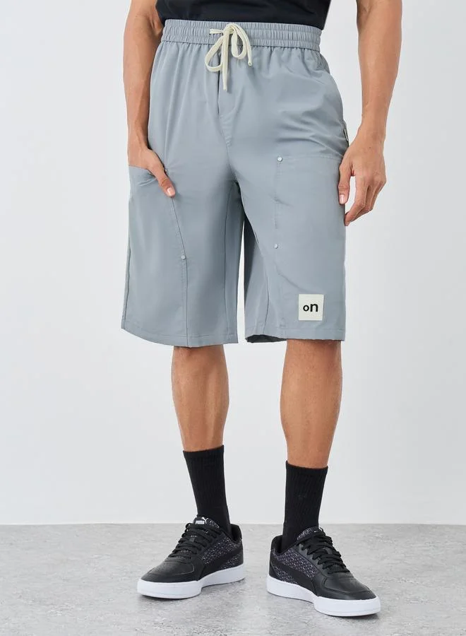 ستايلي Styli Men Grey Oversized Shorts with Badge Detail