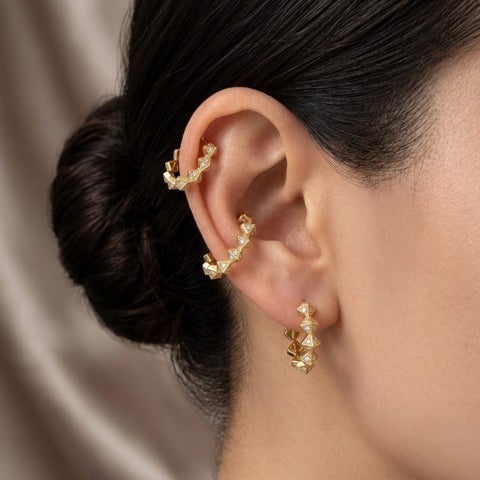 A set of 3 pairs of luxurious earrings, all the same size, featuring a geometric design with semi-circles and interlocking triangles, adorned with zircon stones. A harmonious and modern style!