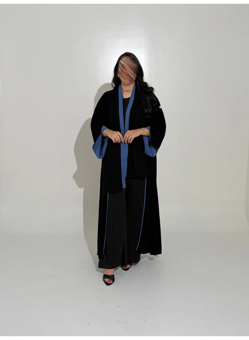 Tori-abaya Royal-style abaya with a blue cuff detail.