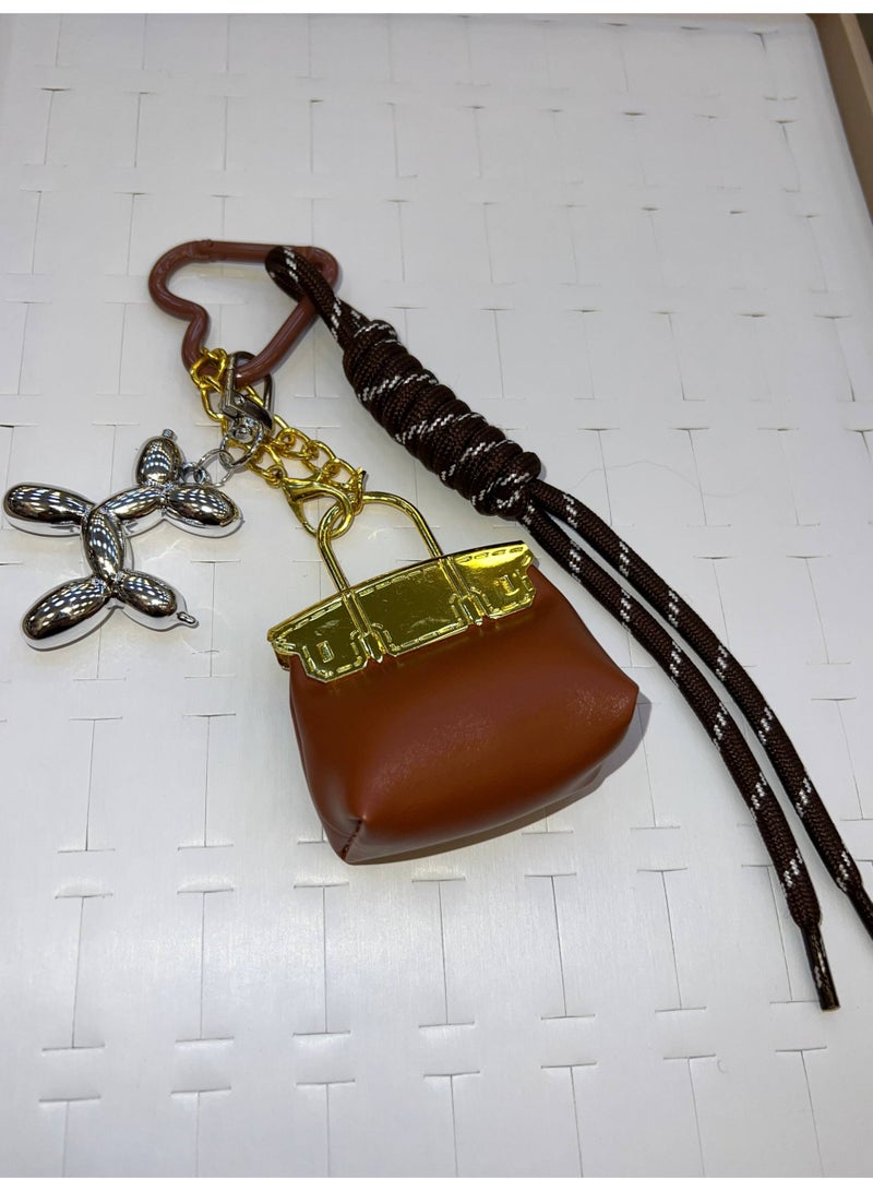 A stylish heart-shaped bag and keychains in assorted colors - Image 1