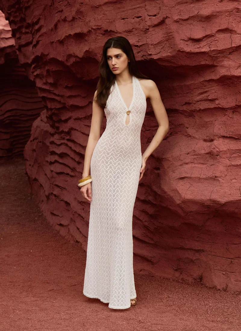 Maxi dress in openwork knit with golden detailing on the bodice