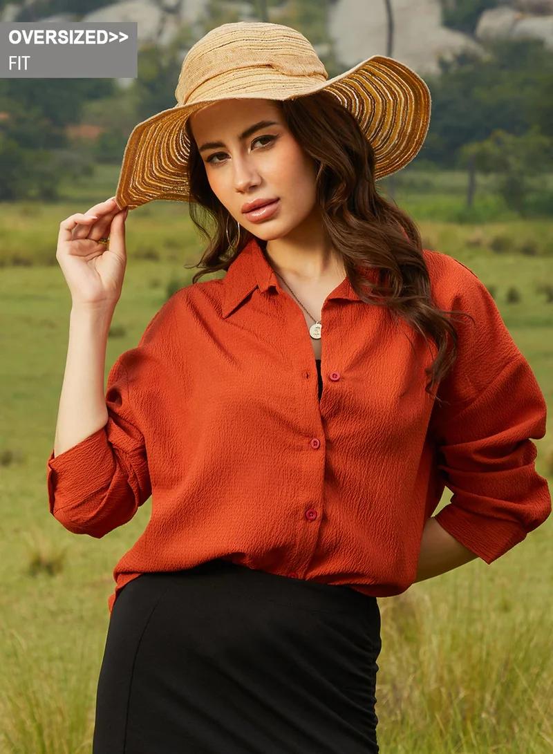 Campus Sutra Campus Sutra Women's Rust Orange Textured Oversized Shirt For Casual Wear | Spread Collar | Long Sleeve | Button Closure | Oversized Shirt Crafted With Comfort Fit For Everyday Wear