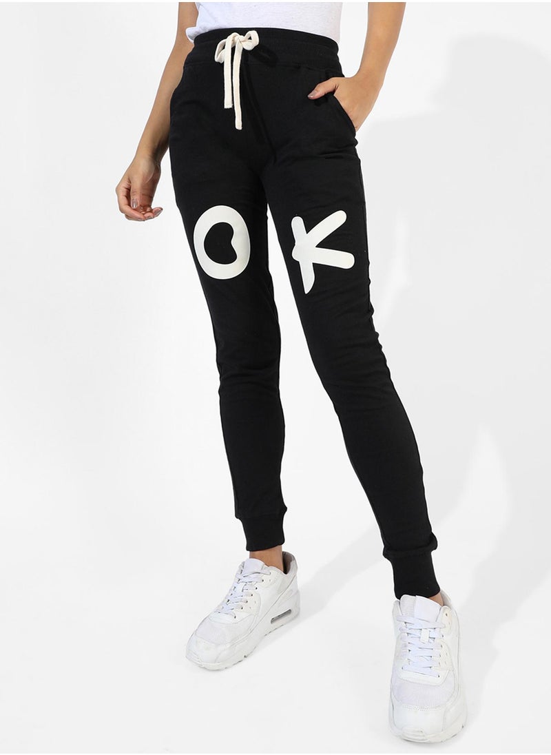 Campus Sutra Campus Sutra Women's Black Printed Regular Fit Trackpants | Slanted Open Pockets | Drawstring Waist | Trackpants Crafted With Comfort Fit & High Performance For Everyday Wear  - Image 1
