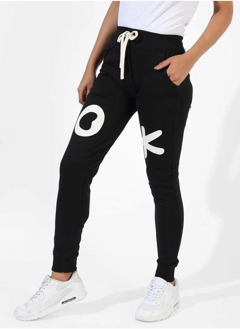 Campus Sutra Campus Sutra Women's Black Printed Regular Fit Trackpants | Slanted Open Pockets | Drawstring Waist | Trackpants Crafted With Comfort Fit & High Performance For Everyday Wear