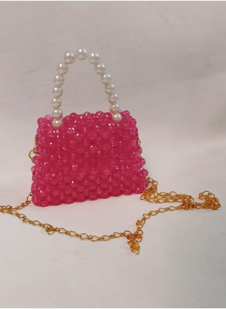 A hand-made bag made o crystal fuchsia in color with an imported pearl handle and a long one meter long gold-plated metal strap. The bag is 13 cm wide and 9 cm long. It is very suitable for children for daily use and evening parties - pzsku/Z54A2852172CCF9634D8BZ/45/1748012192/8acf2aaa-7bc0-444d-855e-560fdfd95410