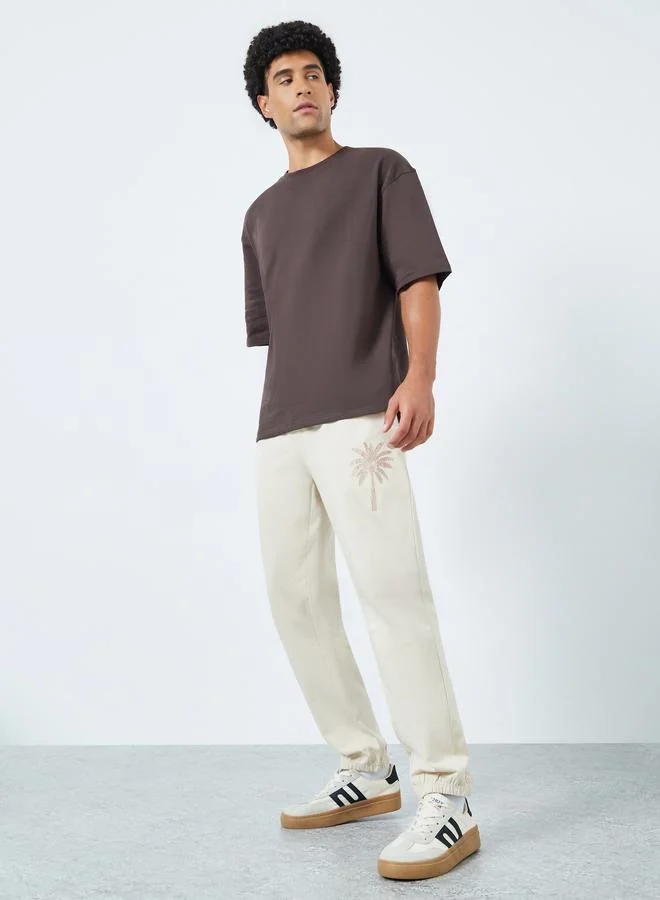 Styli Men Khaki Embroidered Palm Tree Joggers