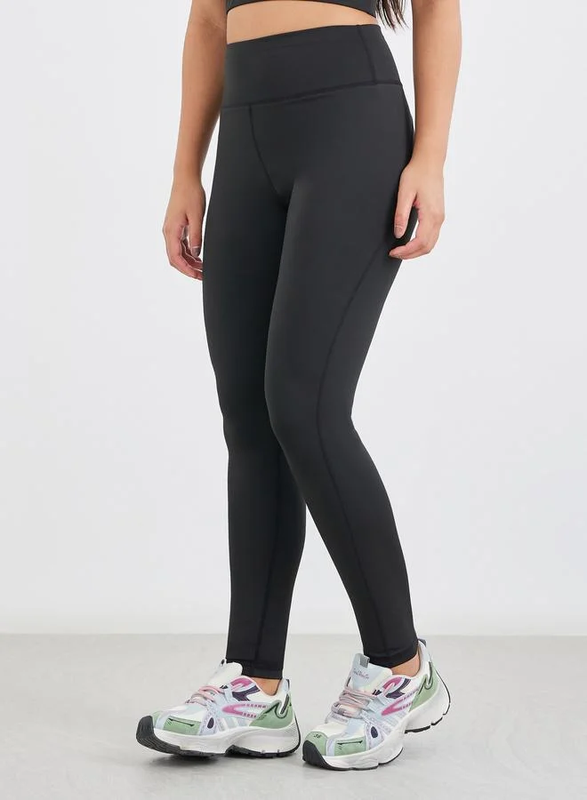 Styli Styli Twist Knot Open Back Short Sleeve Top with Back Mesh Sports Bra and Leggings Set