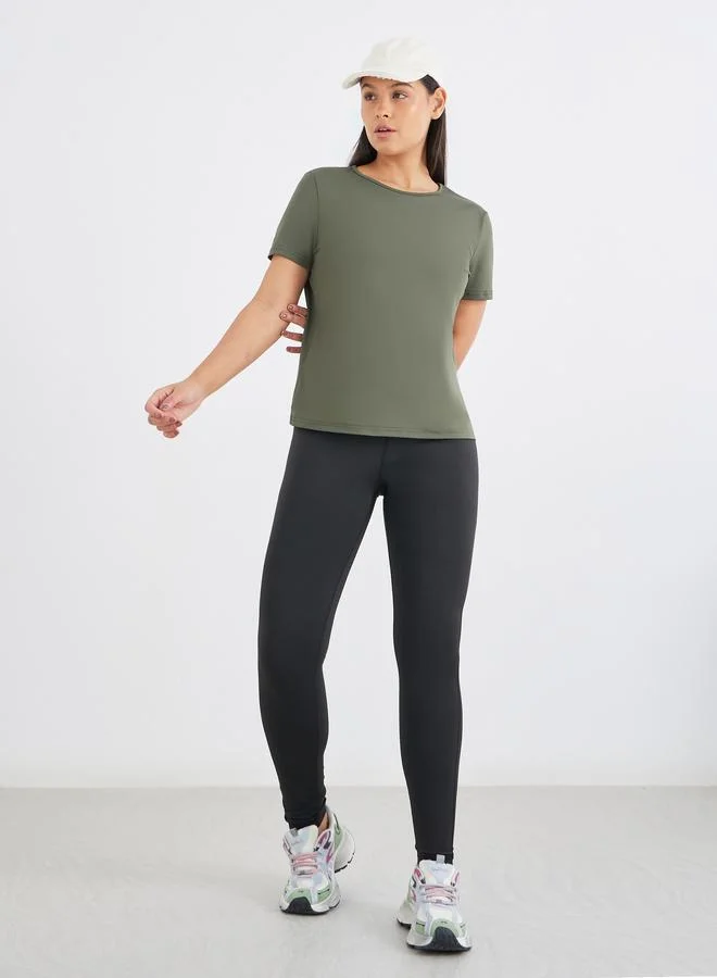 Styli Active Twist Knot Open Back Short Sleeve Top with Back Mesh Sports Bra and Leggings Set