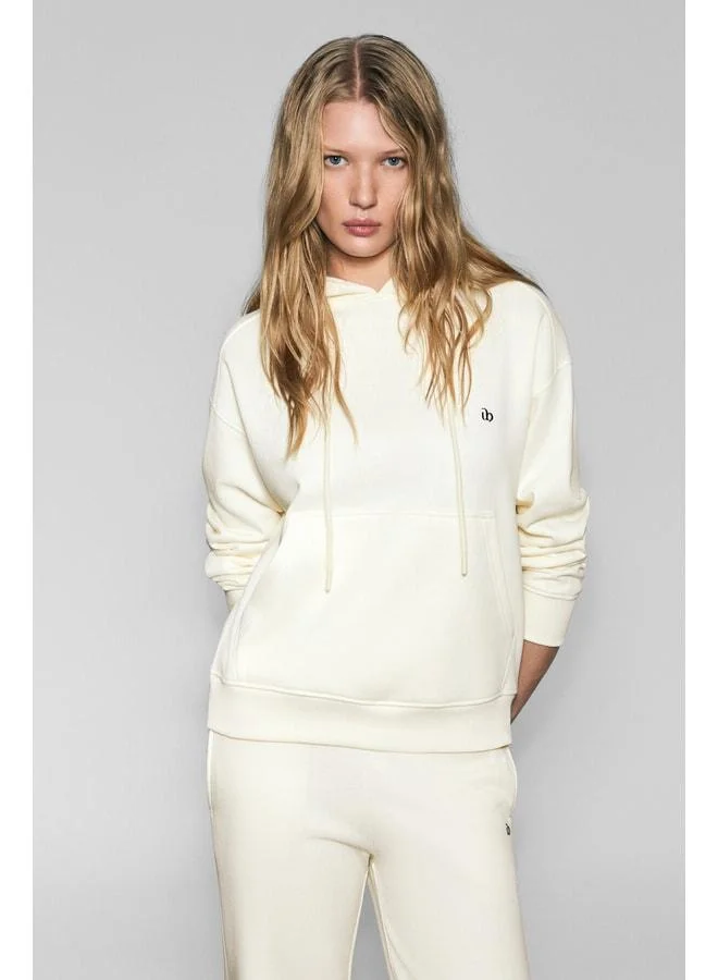 URBAN BEAT JINGSO Women's Soft Fleece-Lined Hooded Sweatshirt with Kangaroo Pocket and Print Detail in Ecru.