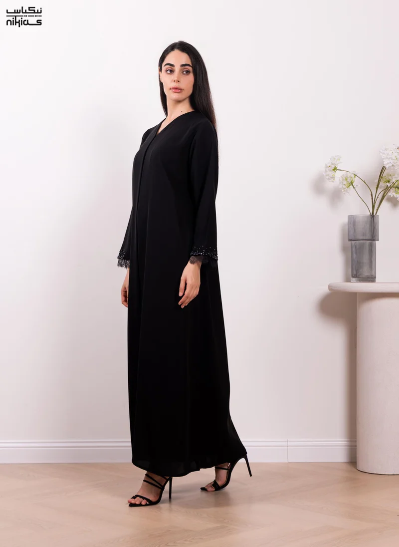 نيكياس Nikias Elegant Cobra Crepe abaya featuring exquisite dantel and handwork