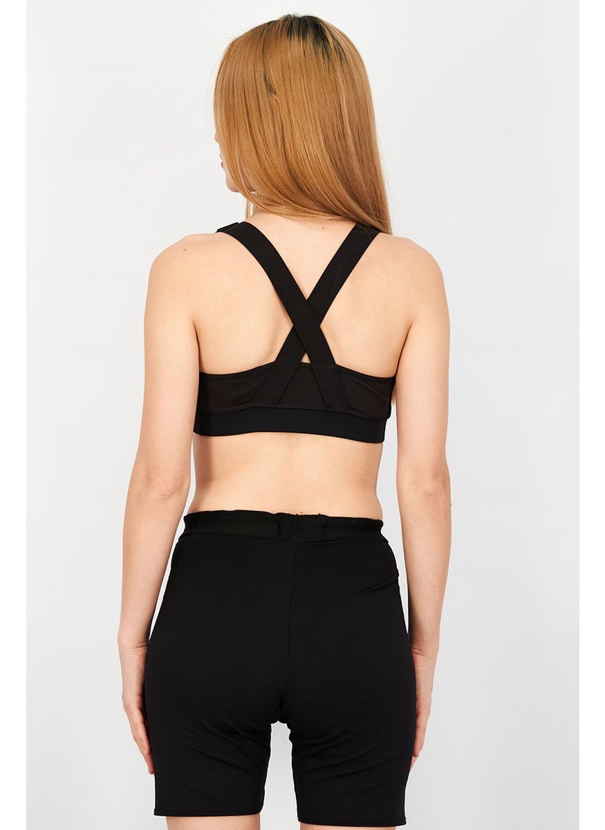 PUMA Women Sportswear Fit Graphic Print Padded Training Bra, Black  - Image 3