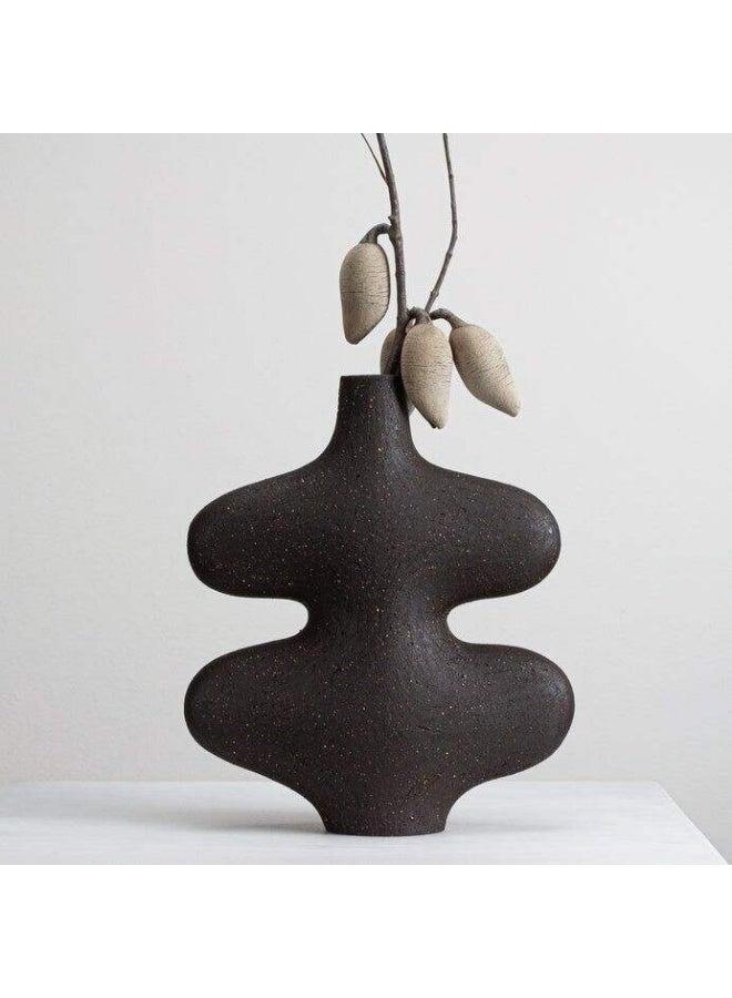 A wavy ceramic vase with an artistic design that adds a touch of elegance to your home. Black color.