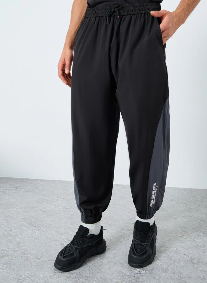 Styli Active Men Black Placement Print Regular Fit Track Pants with Side Panel