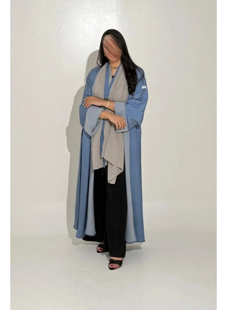Tori-abaya Sky-blue silk abaya with wide sleeves.