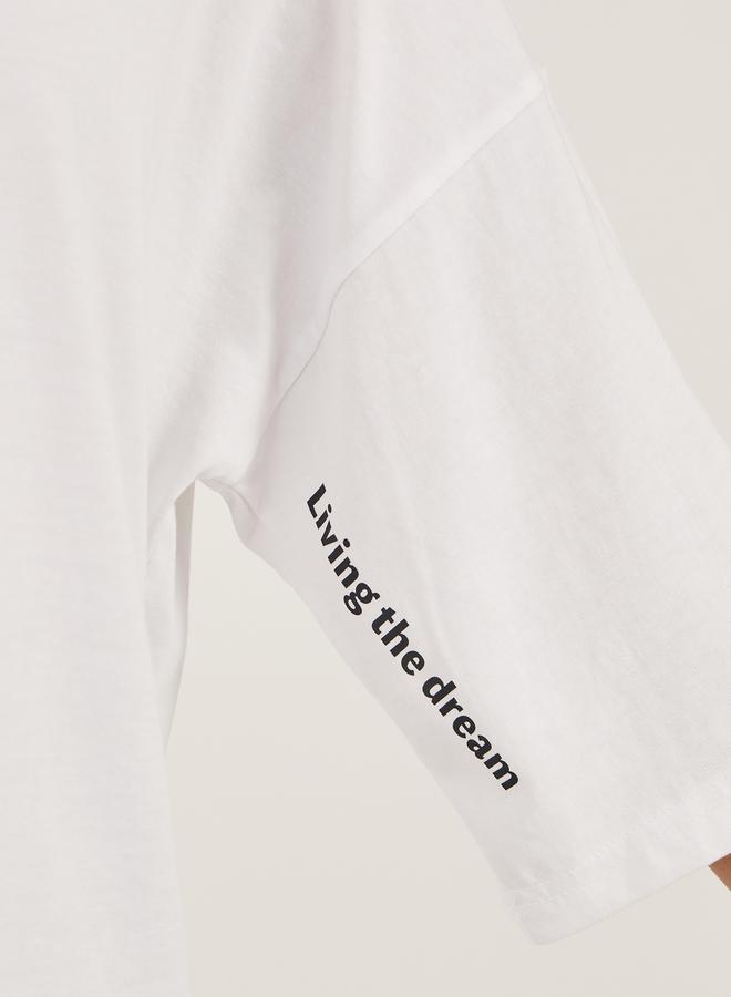 ستايلي تيشيرت واسع بطباعة شعار وأكتاف ساقطة - Image 3