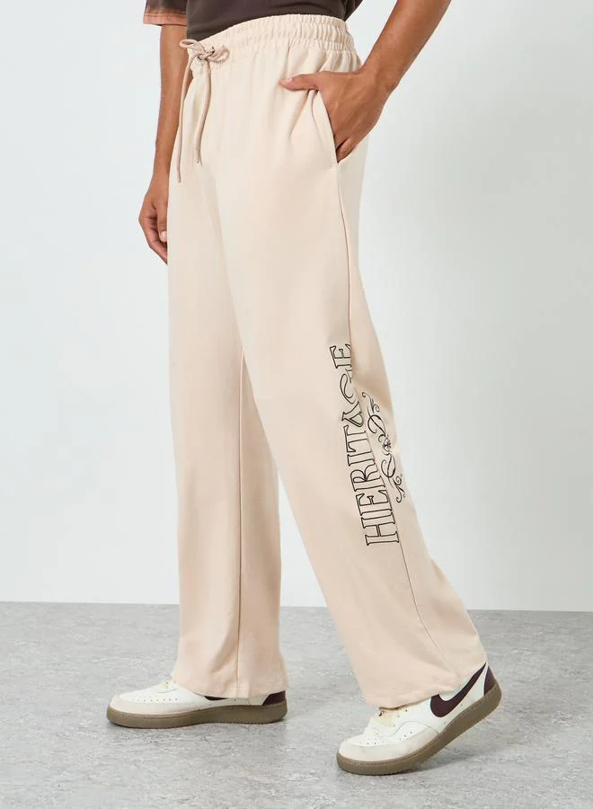 Men Beige Graphic Print Oversized Joggers