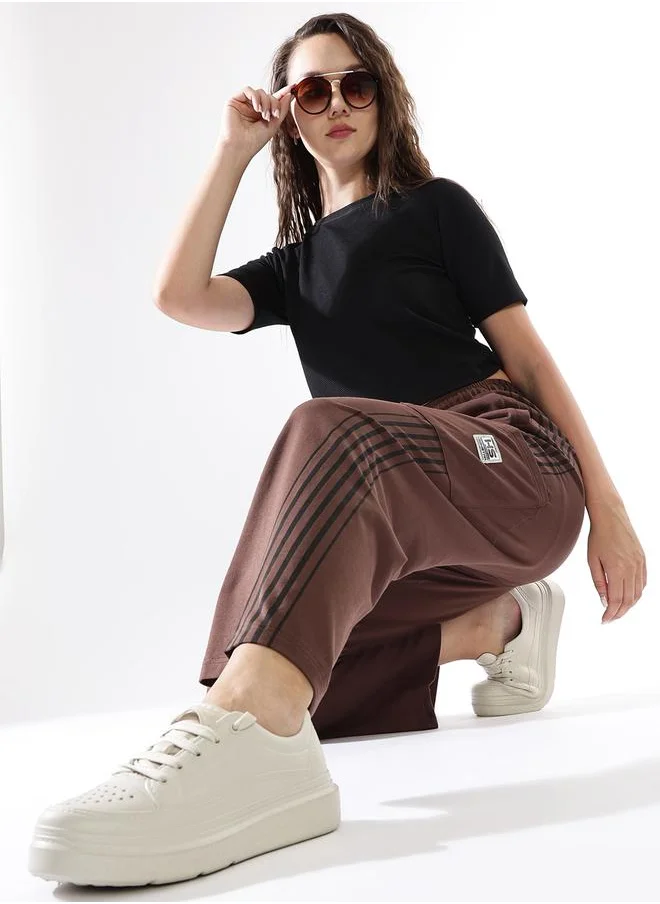 هاي ستار Women Track Pants in Brown featuring Wide Leg fit with a solid pattern, no sleeves, regular length, secured with elasicated + drawstring closure, crafted from terry – crafted for those who appreciate style and comfort.