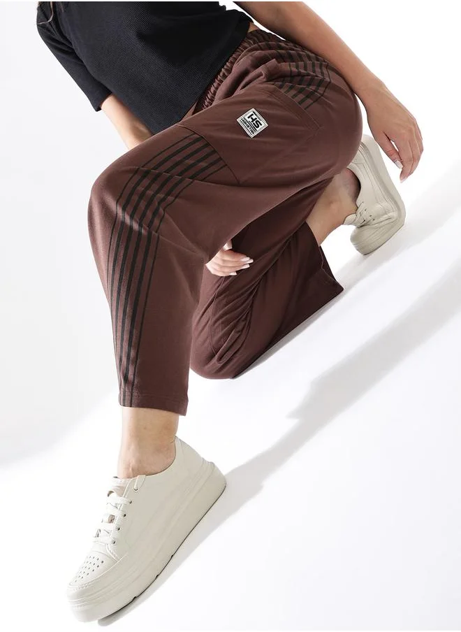 هاي ستار Women Track Pants in Brown featuring Wide Leg fit with a solid pattern, no sleeves, regular length, secured with elasicated + drawstring closure, crafted from terry – crafted for those who appreciate style and comfort.