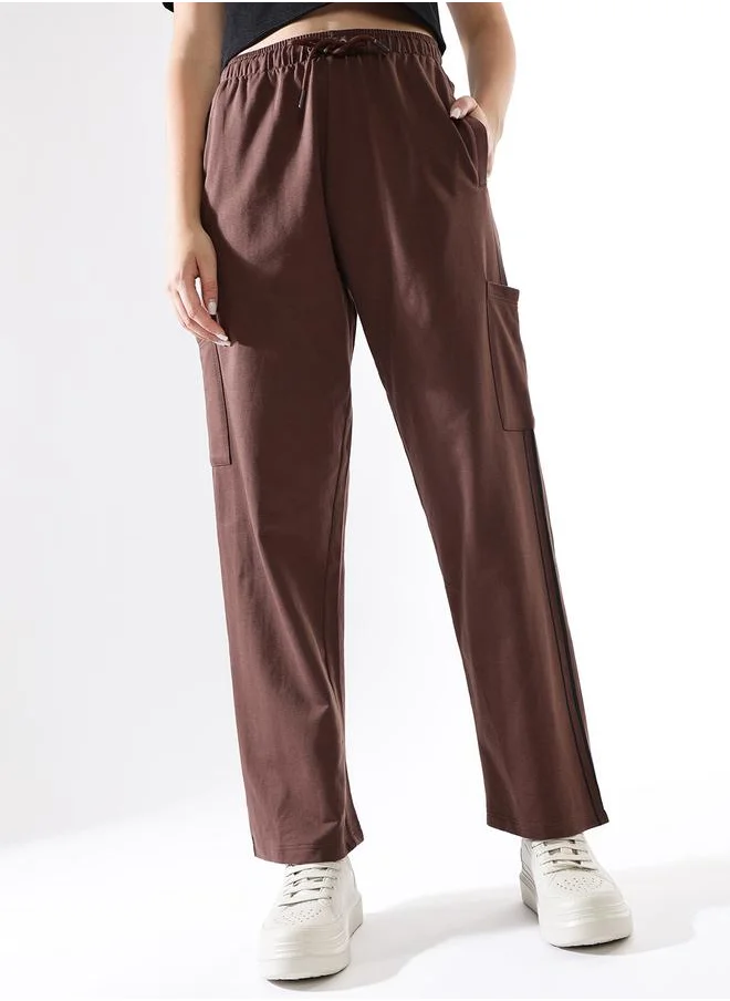 هاي ستار Women Track Pants in Brown featuring Wide Leg fit with a solid pattern, no sleeves, regular length, secured with elasicated + drawstring closure, crafted from terry – crafted for those who appreciate style and comfort.