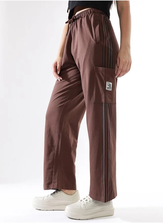 هاي ستار Women Track Pants in Brown featuring Wide Leg fit with a solid pattern, no sleeves, regular length, secured with elasicated + drawstring closure, crafted from terry – crafted for those who appreciate style and comfort.