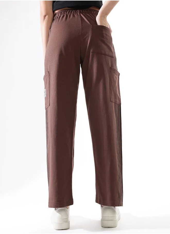 هاي ستار Women Track Pants in Brown featuring Wide Leg fit with a solid pattern, no sleeves, regular length, secured with elasicated + drawstring closure, crafted from terry – crafted for those who appreciate style and comfort.