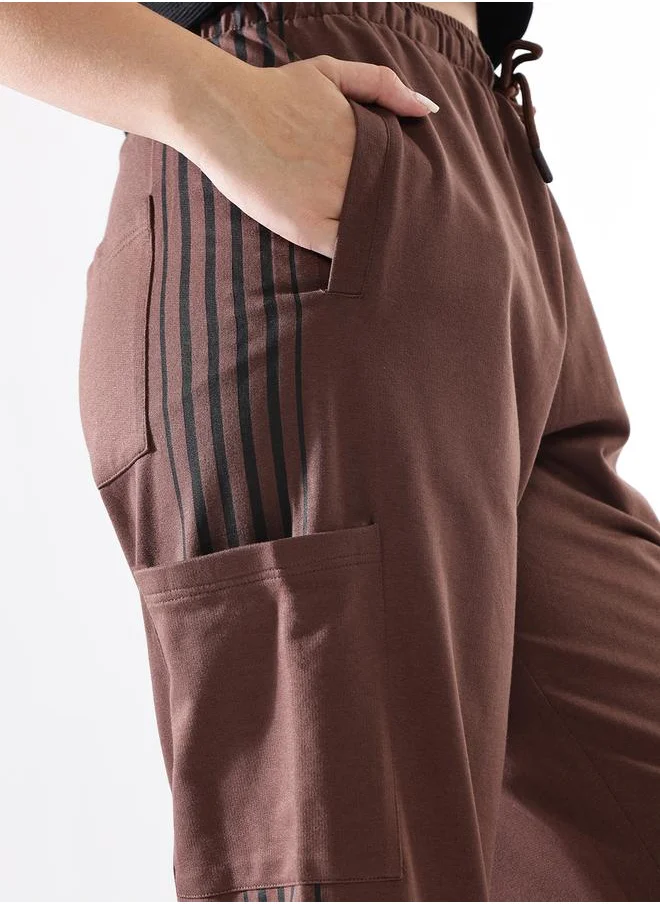 هاي ستار Women Track Pants in Brown featuring Wide Leg fit with a solid pattern, no sleeves, regular length, secured with elasicated + drawstring closure, crafted from terry – crafted for those who appreciate style and comfort.